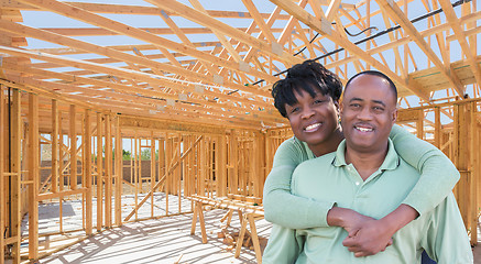 Image showing Happy African American Couple Inside Construction Framing of New