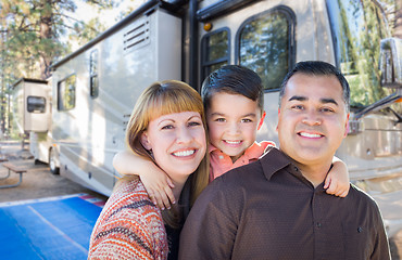 Image showing Happy Young Mixed Race Family In Front of Their Beautiful RV At 