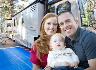 Image showing Happy Young Military Family In Front of Their Beautiful RV At Th