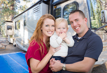 Image showing Happy Young Military Family In Front of Their Beautiful RV At Th