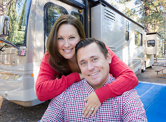 Image showing Happy Caucasian Couple In Front of Their Beautiful RV At The Cam