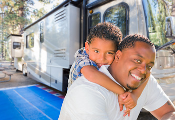 Image showing African American Father With Mixed Race Son In Front of Their Be