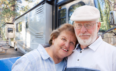 Image showing Senior Couple In Front of Their Beautiful RV At The Campground.