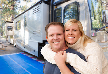 Image showing Happy Caucasian Couple In Front of Their Beautiful RV At The Cam
