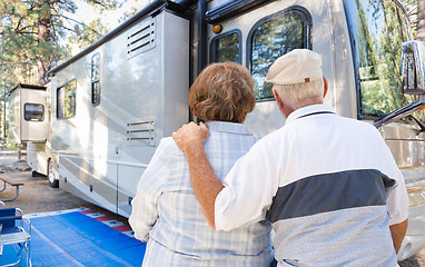 Image showing Senior Couple Looking At A Beautiful RV At The Campground.