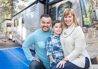 Image showing Happy Young Mixed Race Family In Front of Their Beautiful RV At 