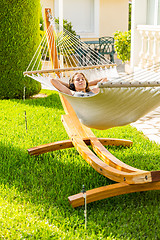 Image showing Girl relaxing and listening to music in hammock
