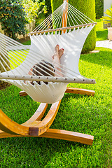 Image showing Girl relaxing and listening to music in hammock