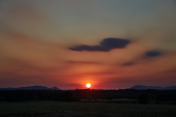 Image showing Sunset with distant landscape