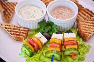 Image showing toast with cheese vegetables and olive on the stick