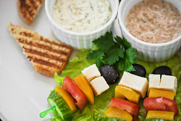 Image showing toast with cheese vegetables and olive on the stick