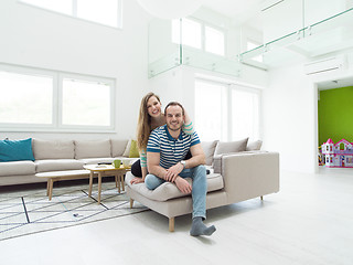 Image showing young handsome couple hugging on the sofa