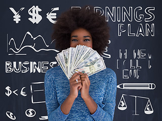 Image showing black woman holding money on gray background