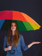 Image showing handsome woman with a colorful umbrella