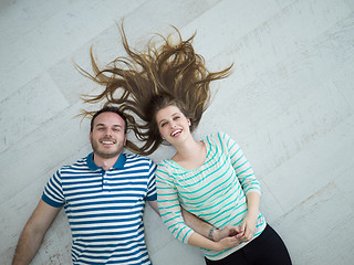 Image showing handsome couple lying on floor