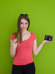 Image showing smilling girl taking photo on a retro camera