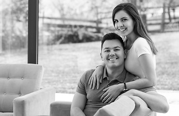 Image showing Two cheerful lovers sitting on the couch