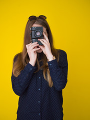 Image showing young girl taking photo on a retro camera