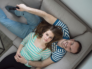 Image showing young handsome couple hugging on the sofa