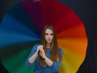 Image showing handsome woman with a colorful umbrella