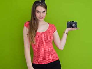 Image showing smilling girl taking photo on a retro camera