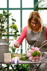 Image showing Woman florist. Focused on flowers