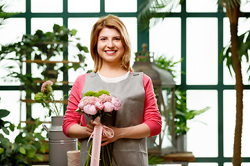 Image showing Young smiling model in greenhouse