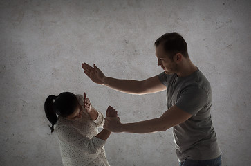 Image showing couple having fight and man beating woman