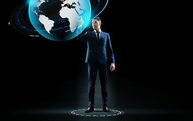 Image showing businessman in suit touching earth globe hologram