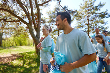 Image showing volunteers with garbage bags walking outdoors