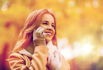 Image showing woman calling on smartphone in autumn park