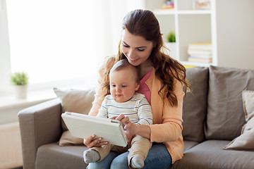 Image showing happy mother with baby and tablet pc at home