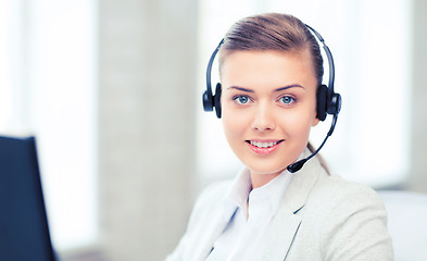 Image showing female helpline operator with headphones