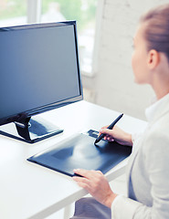 Image showing businesswoman with drawing tablet in office