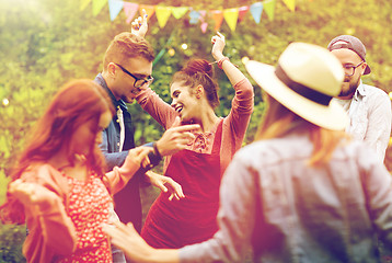 Image showing happy friends dancing at summer party in garden