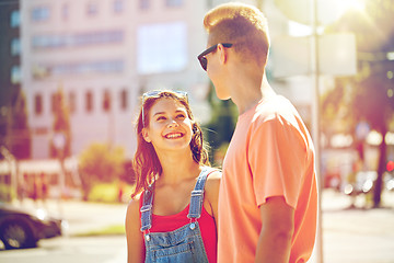 Image showing happy teenage couple looking at each other in city