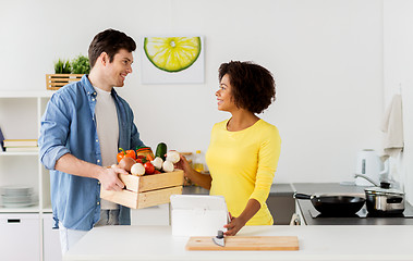 Image showing happy couple with healthy food at home kitchen