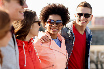 Image showing happy teenage friends in shades talking on street