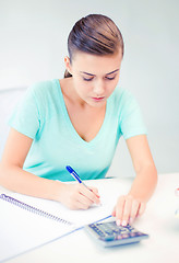 Image showing student girl with notebook and calculator