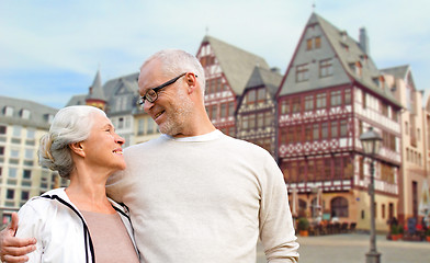 Image showing senior couple hugging over frankfurt background