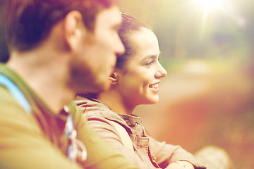 Image showing smiling couple with backpacks in nature