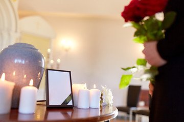 Image showing cremation urn and woman at funeral in church