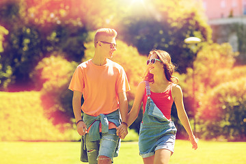 Image showing happy teenage couple walking at summer park