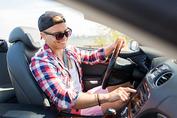 Image showing happy young man driving convertible car