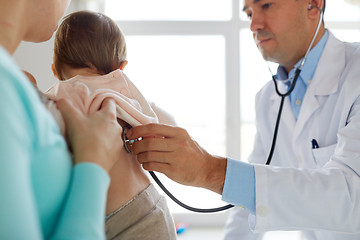 Image showing doctor with stethoscope listening baby at clinic