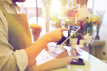 Image showing close up of man with tablet pc at flower shop