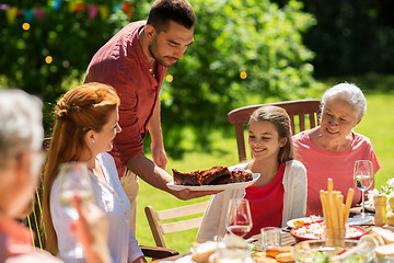 Image showing happy family having dinner or summer garden party