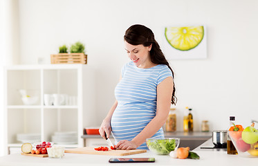 Image showing pregnant woman cooking vegetables at home