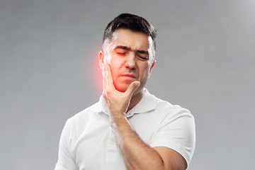 Image showing unhappy man suffering toothache