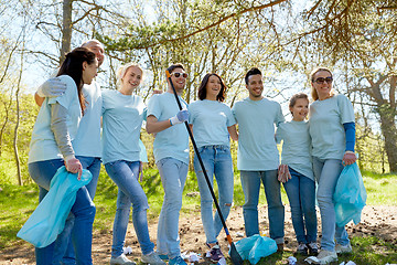 Image showing volunteers with garbage bags cleaning park area